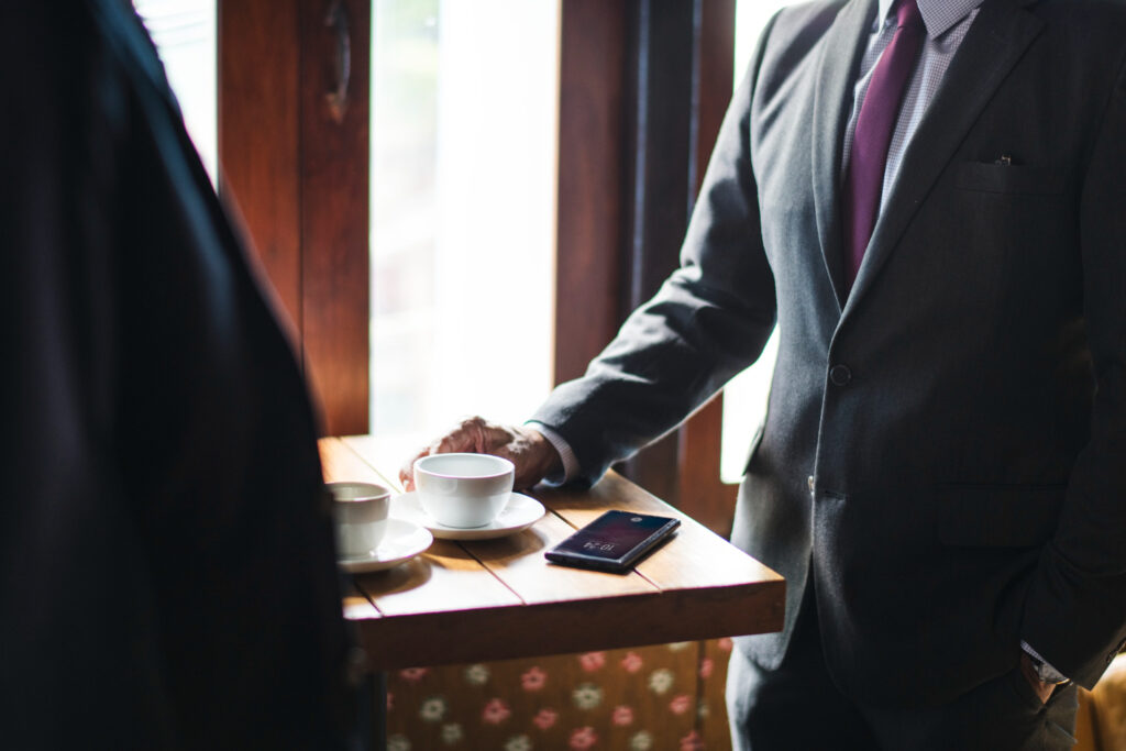 Image of executives using their devices in a coffee shop