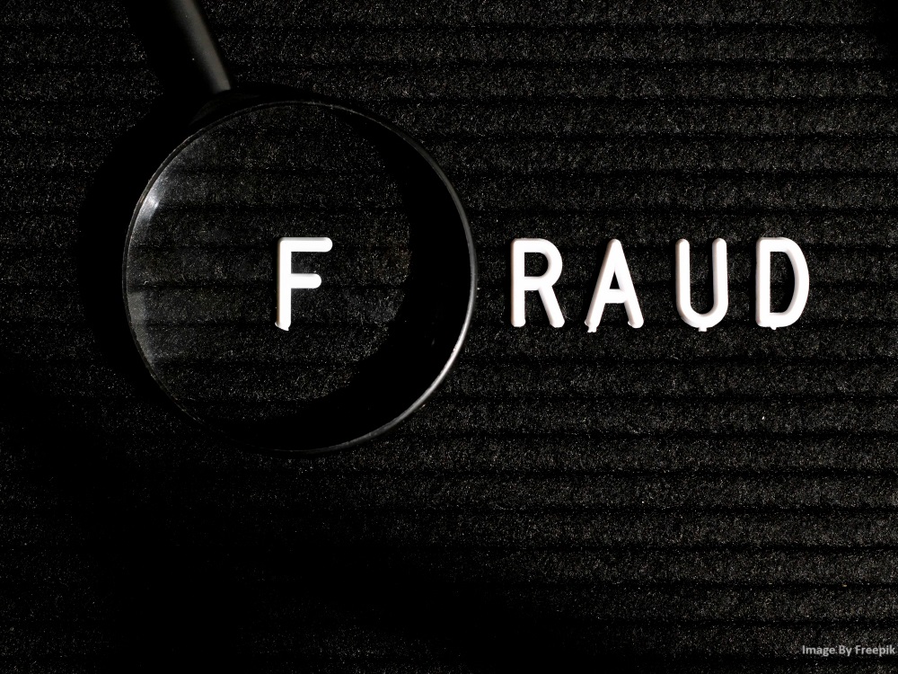Image of the word fraud with a magnifying glass.