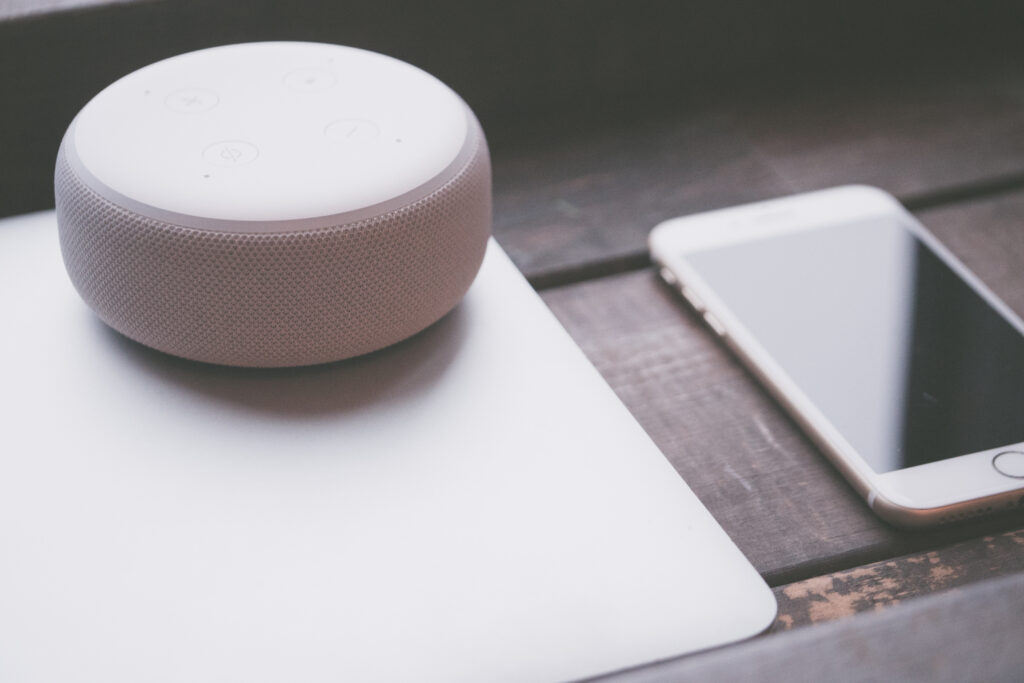 Image of Amazon Echo on a table with a phone and laptop